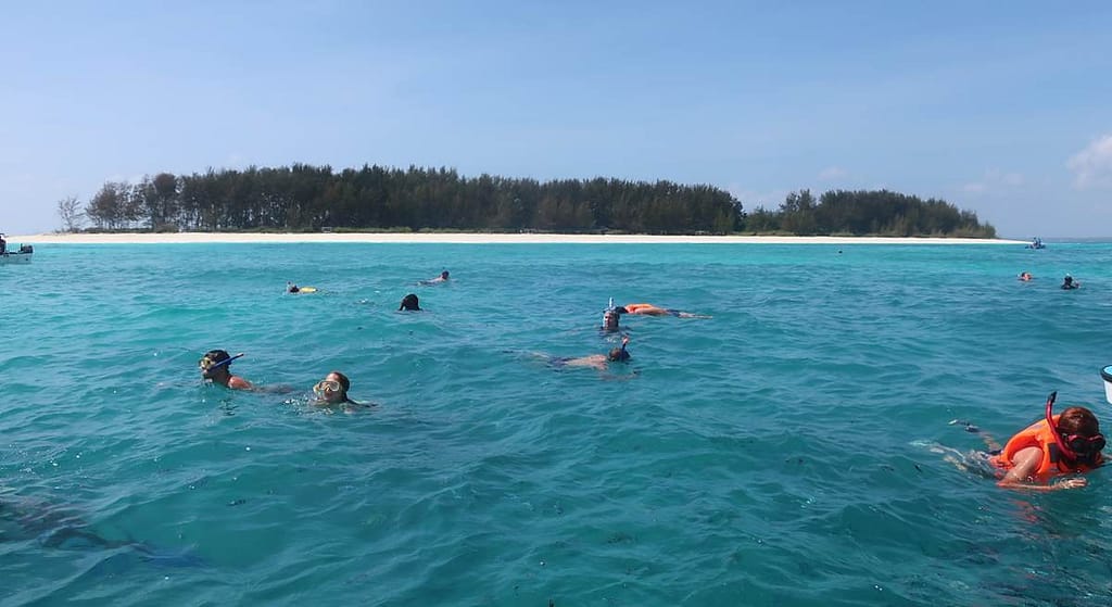 above the water with the island of Mnemba in view